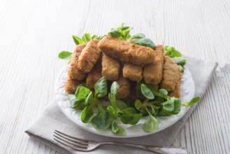 Home-baked fish sticks with salad