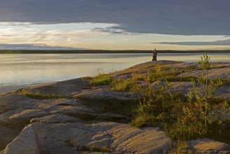 Evening on the White Sea. Stone pillar on coastal granite rock. Kandalaksha Gulf, Karelia, Russia,
