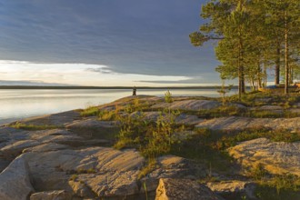Evening on the White Sea. Stone pillar on coastal granite rock. Kandalaksha Gulf, Karelia, Russia,