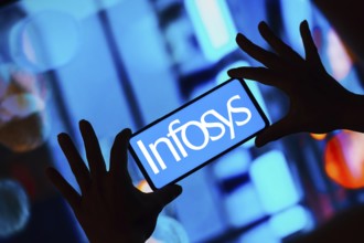 In this photo illustration, the Infosys Limited logo is displayed on a smartphone screen