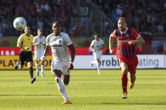 Football match, Junior ADAMU SC Freiburg left and Benedikt GIMBER 1. FC Heidenheim chase the ball