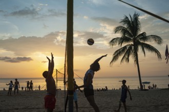 18.11.2019, Phuket, Thailand, Asia, A group of locals playing volleyball on Karon Beach at sunset,