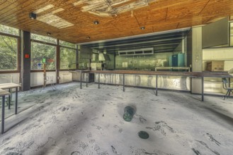 Abandoned, dusty laboratory with daylight streaming in and broken furniture, Institute of Molecular
