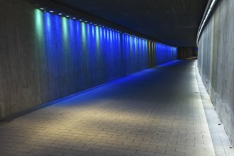 Empty underground concrete tunnel with colorful lighting
