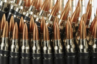 Chain of bullets over white, closeup, horizontal