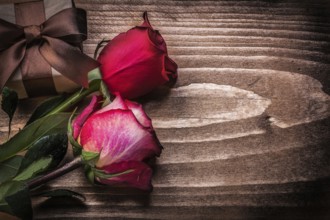 Red roses giftbox on wooden board holidays concept