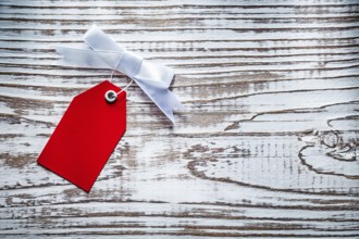 Red shopping tag on vintage wooden board