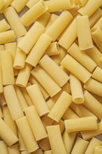 Short-cut uncooked pasta backdrop food and drink concept