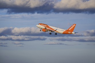 Lisbon, Portugal - Apr 29, 2024: EasyJet Airbus 320 aircraft shot mid-flight, ascending into clear