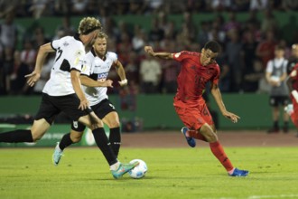 Football match, Jamal MUSIALA FC Bayern Munich right is stopped by Philipp STROMPF SSV Ulm, in the