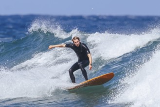 BELLS BEACH, AUSTRALIA, JANUARY 26 2024: Surfers in action at the iconic Bells Beach on a warm