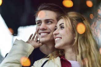 Beautiful couple in love dating outdoors and smiling. Beautiful girl embraces the guy