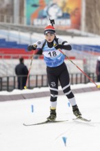 Korean sportswoman biathlete Choi Yoonah skiing on distance biathlon stadium during Open regional