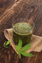 Healthy cannabis smoothie on wooden background. Natural supplement, detox and healthy living