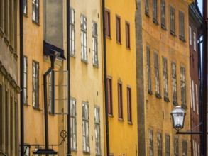 Narrow street with historic colourful facades, typical architecture of a Scandinavian city,