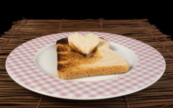 Toast with heart-shaped set in white plate