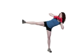 A beautiful young woman practicing martial arts kickboxing