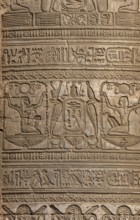 Hieroglyphic carvings on the exterior walls of an ancient egyptian temple