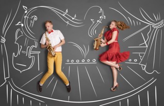 Love story concept of a romantic couple against chalk drawings background. Musician couple playing
