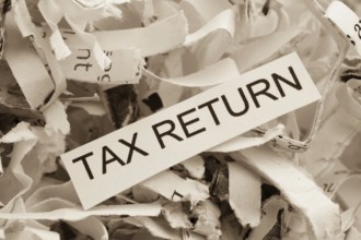 Paper shreds with the keyword Tax Return, symbolic photo for data destruction, data protection and