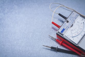 Electrician's instrument of measurement on scratched metallic background construction concept