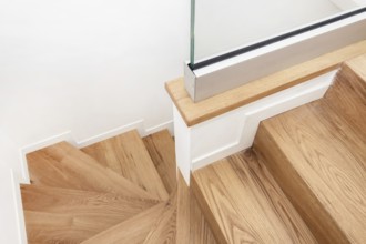 Modern residential wooden stairs. Wood staircase inside contemporary white modern house
