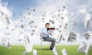 Young businessman is engaged in music, concept of creative chaos in business
