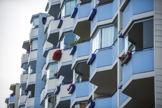 Façade with balconies of an apartment block, also known as a prefabricated building, in the former