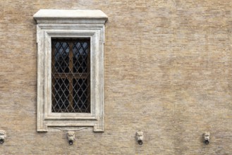 The window with iron gratings on brick wall, for background