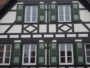 Detailed view of a half-timbered house with green shutters and windows, kandel, pfalz, germany
