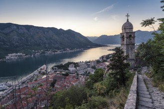 The tower of Church of Our Lady of Remedy and Bay of Kotor view from the hill above the town,