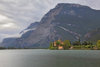 Toblino lake in the mountains of northern Italy and a medieval castle