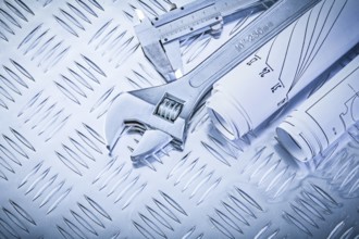 Construction drawings trammel caliper adjustable spanner on grooved metal plate maintenance concept