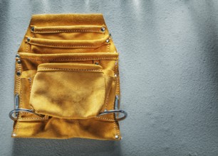 Leather tool belt on concrete background