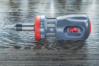 Screwdriver on wooden board top view