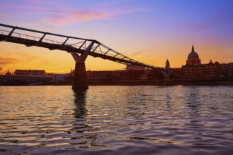 London Millennium bridge sunset skyline in UK at dusk