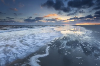 Sunrise over North sea coast during low tide, Schiermonnikoog, Netherlands
