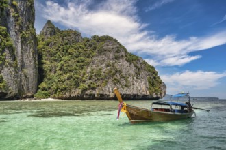 Tropical islands view with long tail boat ocean blue sea water at Pileh Lagoon of Phi Phi Islands,