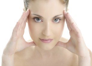 Portrait of young beautiful woman with clean skin at studio