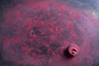 Small school blackboard with red chalk dust on the surface