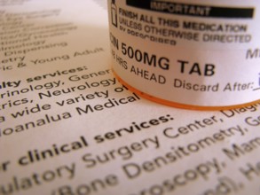 Some prescription medicine on top of some medical documentation