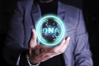 A person holding a holographic display of DNA strands and molecular structures.