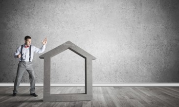 Stone home silhouette in empty room as symbol for real estate insurance