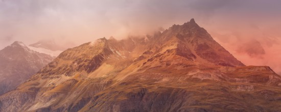 Swiss Alps mountain peaks dramatic sunset view, cloudy sky in Switzerland