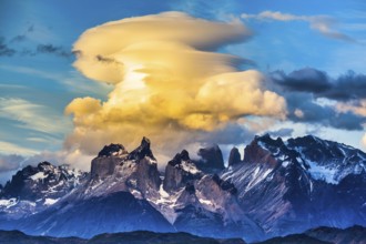 Magnificent cumulus clouds in the rays of the sunset. Torres del Paine National Park. Summer in the