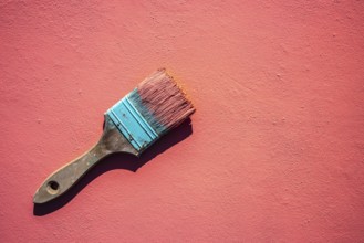 Coral color grunge brush with paint in monochromatic coral background wall
