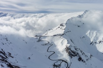 Aerial view of Grossgloknershtrasse in snow. Great high mountain road near Grossglokner mount in
