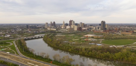 Elevating up over the highway near the downtown city skyline of Columbus Ohio