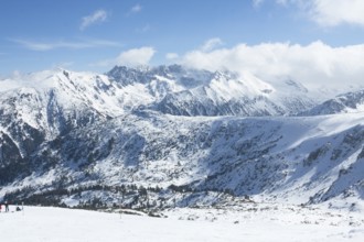 People skiing on alpine skis in mountains in ski resort Bansko, Bulgaria.