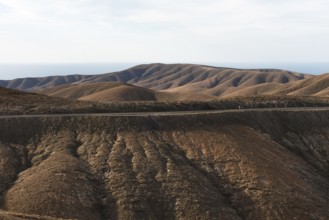 Gentle brown hills under a blue sky in an arid landscape. Viewpoint Mirador Astronomico de